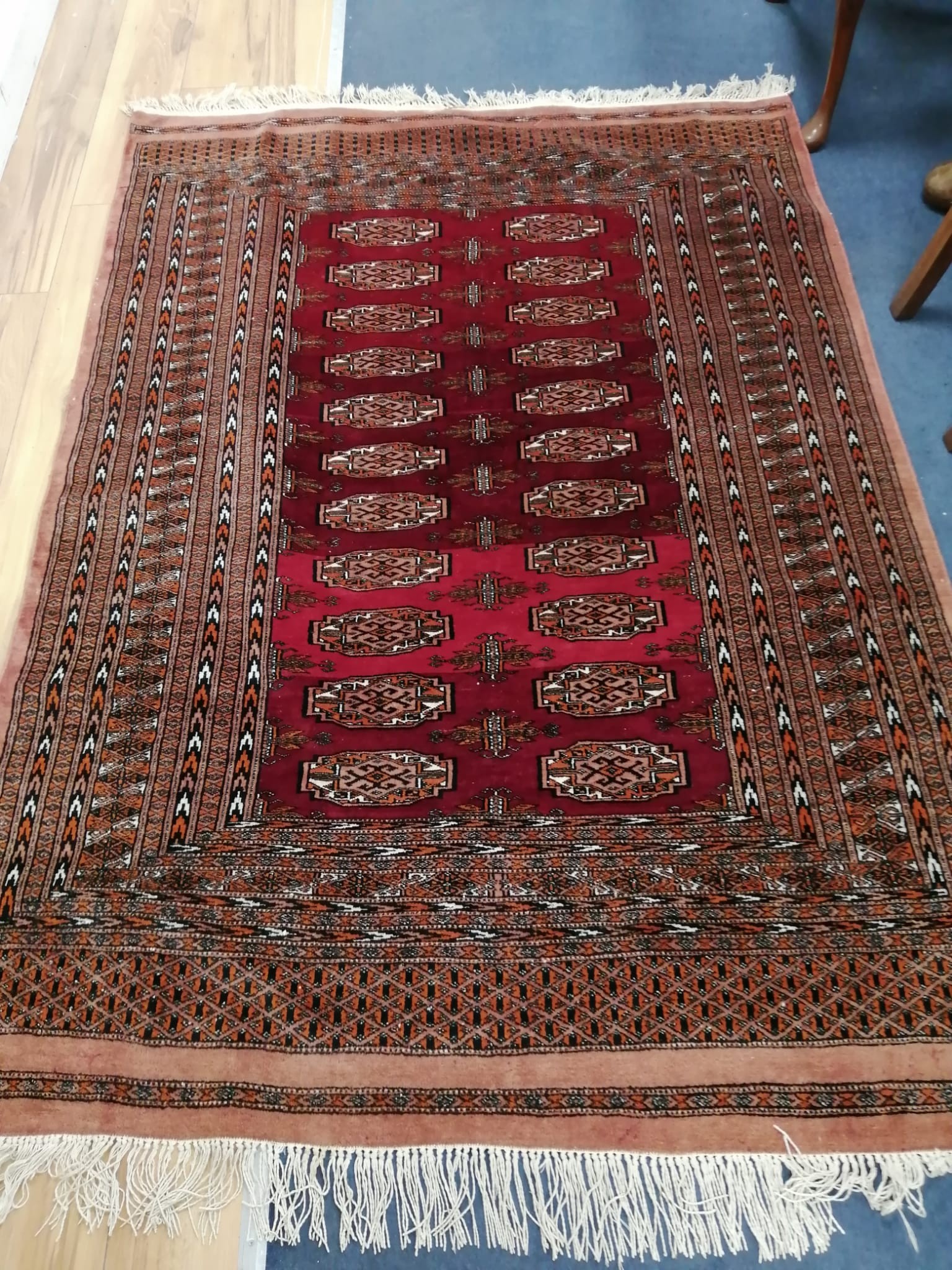 A Bokhara burgundy ground rug, 185 x 132cm
